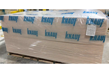 Knauf branded pallet hoods over a crate of plasterboard